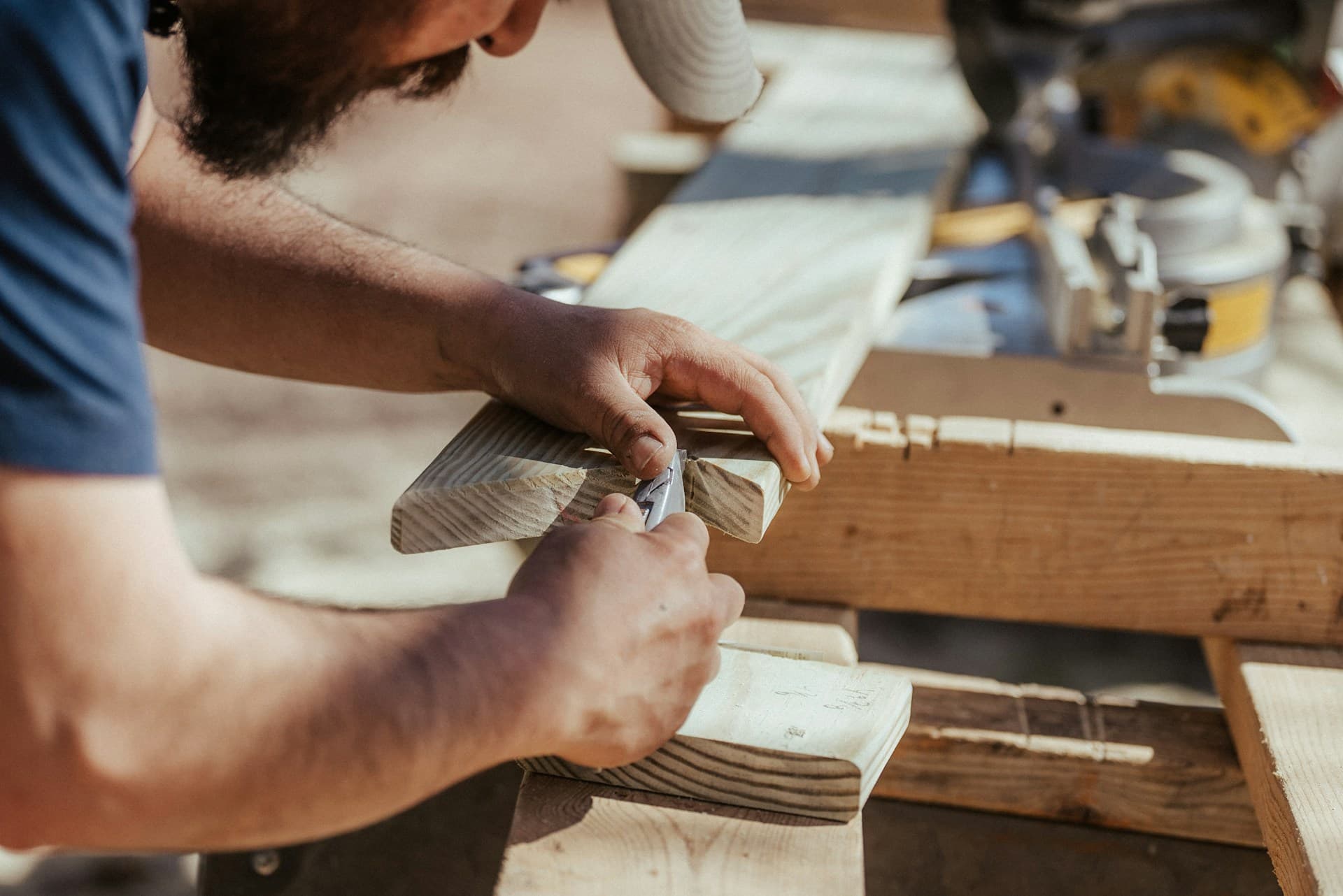 Tradesperson working timber by hand on site