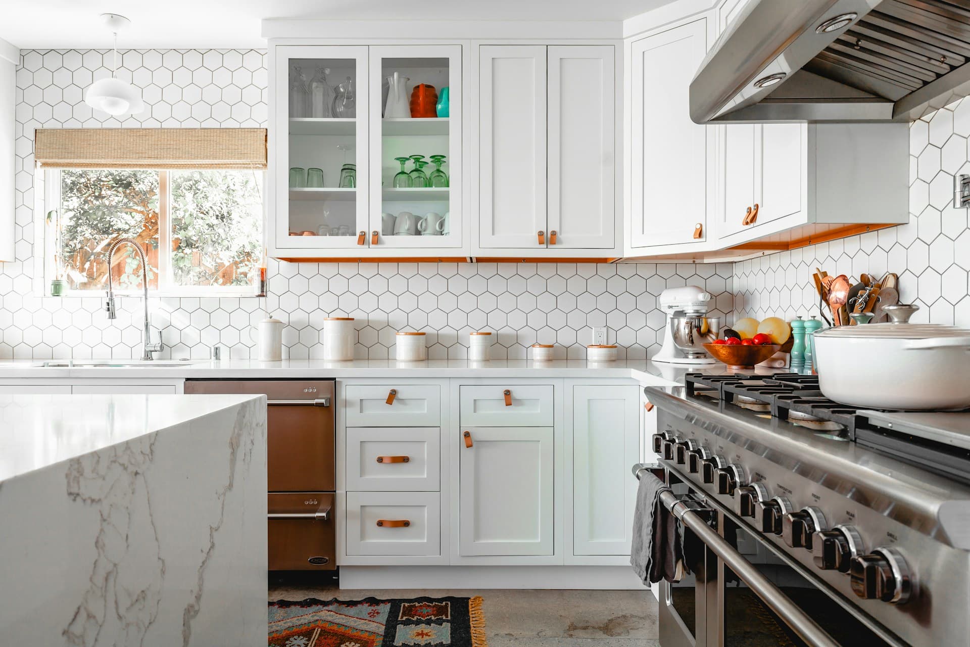 Bright white shaker kitchen with tiled splashback and stainless steel range